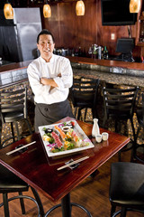 Japanese restaurant chef presenting sushi platter
