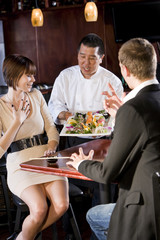 Japanese sushi restaurant, chef serving customers