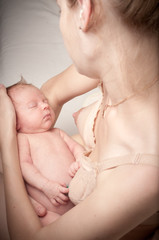 Newborn sleeping child on mothers hands