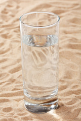glass of water on the sand