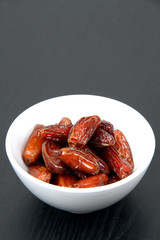Fresh dates in a white bowl