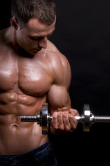 Muscular man with dumbbells.