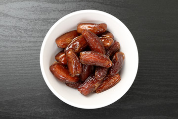 Fresh dates in a white bowl