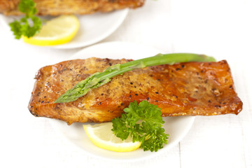 homemade hot smoked salmon fillet, on white with asparagus, pars