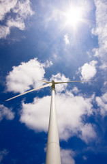 Windmill against a blue sky and clouds, alternative energy sourc