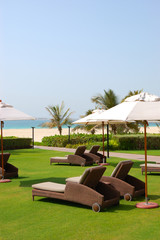 Sunbeds at the beach of luxury hotel, Dubai, UAE