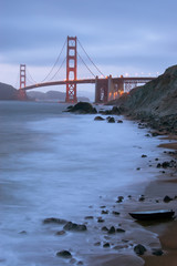Golden Gate Bridge with a boat as seen from Baker Beach.