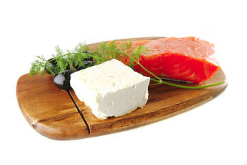smoked salmon on wooden plate with white cheese