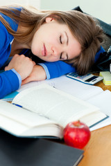 Attractive girl sleeping at her desk