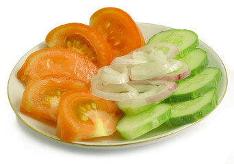 tomatoes, cucumbers, onions on a saucer