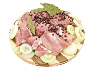 Pieces of meat with seasonings on a board