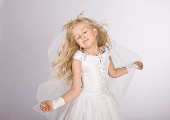 Fototapeta na wymiar little girl in a dress of the bride