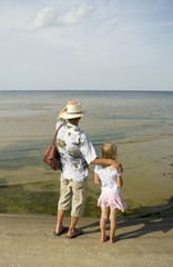 Man and small girl on the beach.