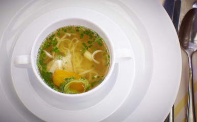 Clear beef broth with noodles and vegetables