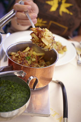 Fried grated potatoes in a copper pot