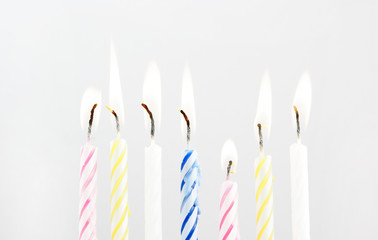 Colored candles on grey background