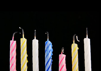 Colored candles on black background