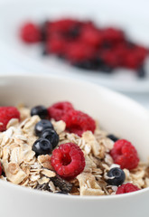 Granola with raspberries and blueberries. Shallow DOF