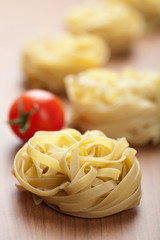 raw pasta tagliatelle and tomatoes