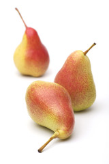 Three ripe yellow-red pears on a white background