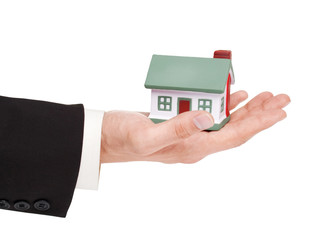 businessman holding a toy house, real estate presentation