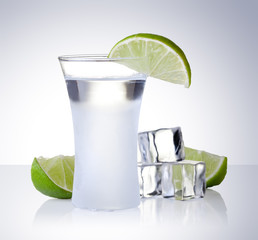 shot glass filled with clear cold alcohol