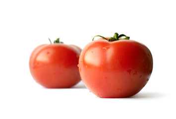 Two tomatoes isolated on white background