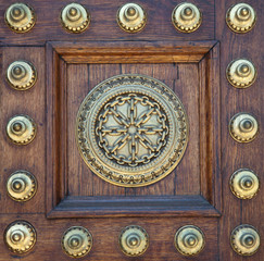 Gold studs and symbol on wooden door - 24481872