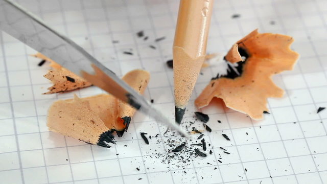 Sharpening the pencil	 with a penknife