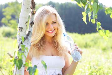 Beautiful girl holding a bottle of water