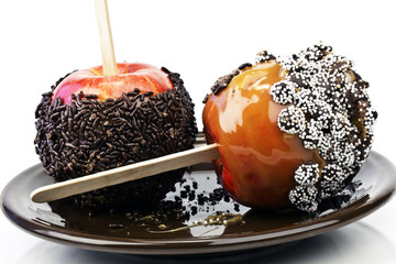 two caramel candy apples with chocolate