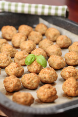 Roast meatballs on baking sheet. Shallow DOF