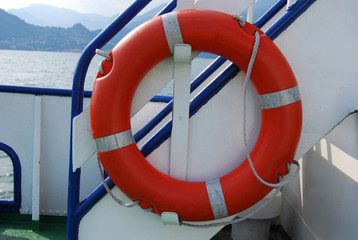 Orange lifebuoy ring on a ship