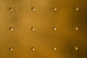 nubs on a scratched golden plastic surface