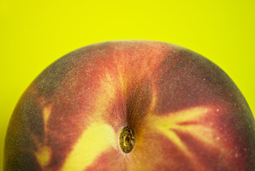 A peach in yellow-green background