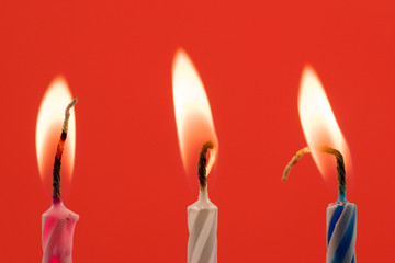 birthday candles , isolated over a red background