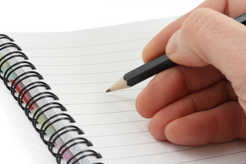 Hand writes a pen on an notebook