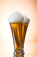 Beer glasses against the colorful gradient background