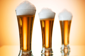 Beer glasses against the colorful gradient background
