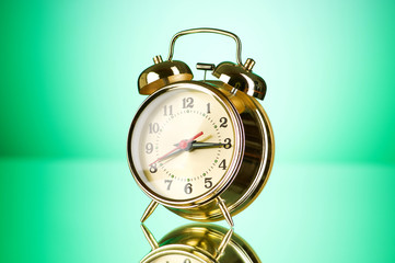 Time concept - alarm clock against colorful background
