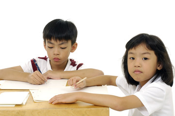 Girl and boy learning on white