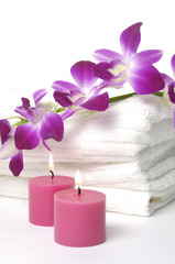 A beautiful orchid, towel and candles