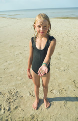 Girl with shells on the hand.