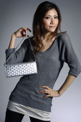 photo of Fashionable young woman with hand bag