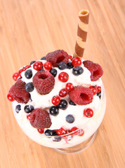 Whipped cream with raspberries, red currants and blue berries