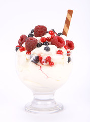 Whipped cream with raspberries, red currants and blue berries