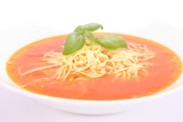 Tomato soup with macaroni decorated with basil