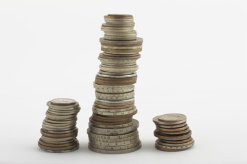 Three columns of coins on white