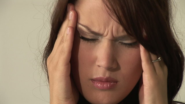 HD1080i Young woman having headache and massaging her head