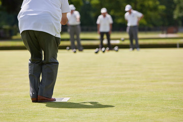 Game of Lawn Bowls - Player about to Bowl © grandaded